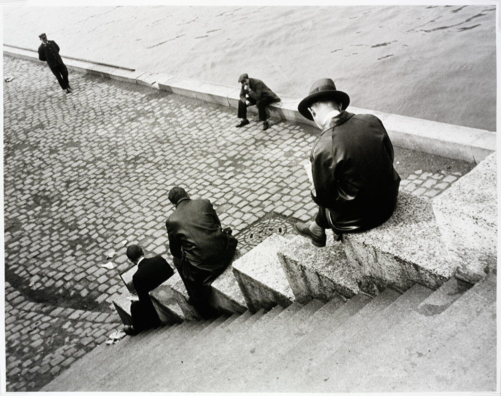 Ilse Bing Three men on steps by the Seine